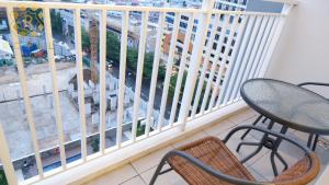 a balcony with a table and chairs and a window at Royal Suites Studio 15th Floor - Citra Plaza Nagoya Apartment in Nagoya