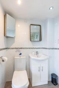 a white bathroom with a toilet and a sink at BEACH VIEW - Amazing Sea Views in Lytham St Annes