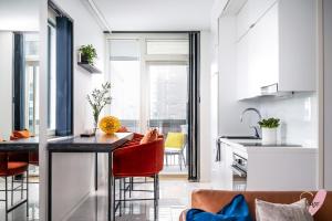 a kitchen and living room with a table and chairs at Elegant apartment in Oulu in Oulu