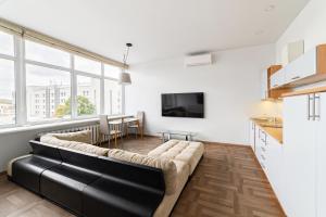 a living room with a couch and a table at Apartament 502 in Kaunas