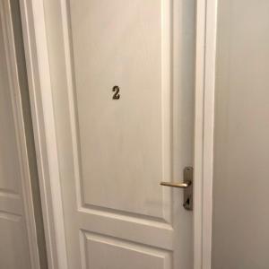 Una puerta blanca con el número dos. en Chambre chez l habitant 2 en Moumour