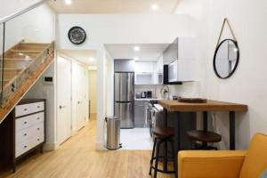 a kitchen with a sink and a counter in a room at 75-A New stylish Loft 1BR W D Prime Upper east in New York