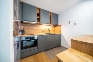 a kitchen with a sink and a stove at 7304 Pure Freude in dieser stilvoll renovierten Wohnung mit moderner Kueche in Vulpera