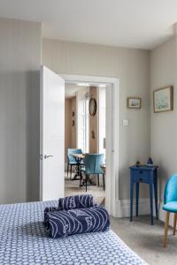 a bedroom with a bed and a blue table and chairs at BEACH VIEW - Amazing Sea Views in Lytham St Annes +12 photos