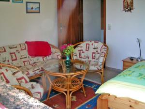 ein Wohnzimmer mit einem Sofa, einem Tisch und Stühlen in der Unterkunft Ferienwohnung Tina in Ahrenshagen