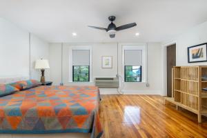 a bedroom with a bed and a ceiling fan at Cherry Street Loft (B) Pet-Friendly & In the Heart of Downtown Black Mtn! in Black Mountain