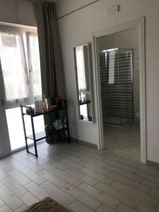 a room with a bathroom with a mirror and a table at fronteMare Faleria in Porto SantʼElpidio