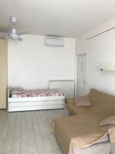 two beds in a room with white walls at fronteMare Faleria in Porto SantʼElpidio +50 photos