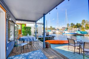 a house with a deck with a table and chairs at Portland Floating Home Getaway with Sauna! in Portland