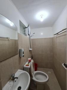 a bathroom with a toilet and a sink at Vacation Transient Guest House Rental Calapan City L43 in Calapan