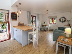 a kitchen and living room with a couch and a table at Croft Cottage in Castleton