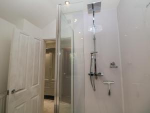 a shower with a glass door in a bathroom at Croft Cottage in Castleton +45 photos