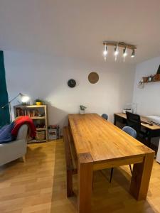 a living room with a wooden table and a couch at Cosy Modern Apartment in Portobello in Dublin