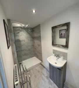 a bathroom with a sink and a shower at Castle View House in Clitheroe
