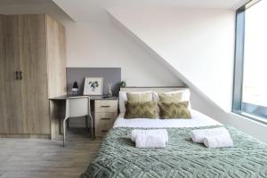 a bedroom with a bed and a desk in it at The Nest LE1 in Leicester