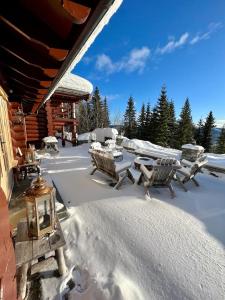 a group of chairs and a table in the snow at Chalet De Luxe 518 in Trysil