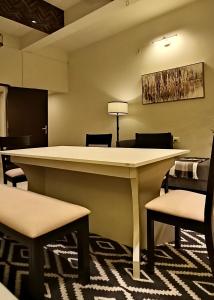 a lobby with a large table and chairs at The Autograph-By Alhanney in Guwahati