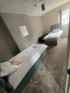 two twin beds in a room with at Ninian Park Road in Cardiff