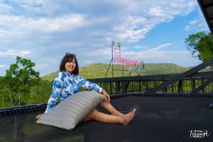 a woman sitting on the back of a truck at Elevated Serenity Lodge in Khao Kho in Khao Kho