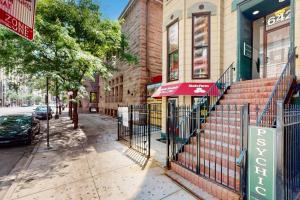 a city street with a gate on the sidewalk at Chic River North Retreat in Chicago