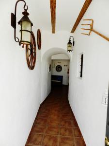 a hallway in a house with lights and a tile floor at Casa Triana in Cuevas del Campo