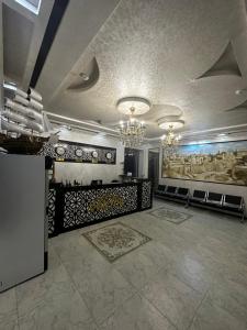 a large room with a large painting on the wall at VOSTOK HOTEL in Bukhara