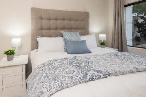 a bedroom with a large bed with a blue and white comforter at The Beach Palace Ramsgate in Margate