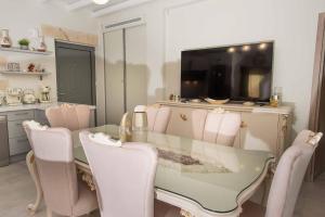 a dining room with a glass table and pink chairs at Villa Stone Diamond in Sívas