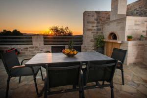 a table and chairs with a bowl of fruit on a patio at Villa Stone Diamond in Sívas