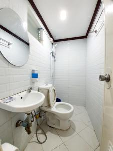 a bathroom with a toilet and a sink at Calapan Transient House Acacia L35 in Calapan