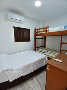 a bedroom with two bunk beds and a desk at Casa Sol Naciente in Cartagena de Indias
