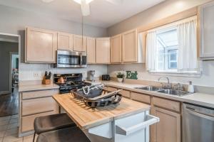 a kitchen with wooden cabinets and a wooden counter top at Pearly Gates l 3 Bed l Sleeps 5 l w 2-Car Garage in Forest Park