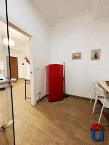a room with a red refrigerator in a white wall at Guest House La Maddalena in Foggia
