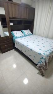 a bedroom with a bed and a mirror at Portinari 2 in Rio das Ostras