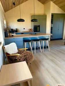 a kitchen with a counter and stools in a room at Hytte til leie i Ryfylke in Hjelmeland