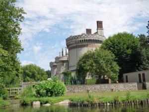 an old castle sitting on the side of a river at Studio Vue Loir, Centre-Ville in Bonneval +8 photos