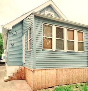 a blue house with a large window at *All-American Home Minutes From Case/UH/Cle Clinic in Cleveland Heights