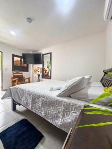 Ένα ή περισσότερα κρεβάτια σε δωμάτιο στο Hotel Randuky Tayrona
