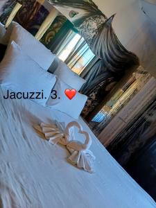 a bed with a heart and a valentinesmsg at Casa Rania in Sibiu