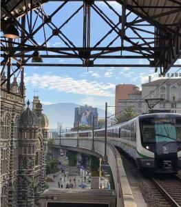 a train is on the tracks in a city at Apartasuites AV in Medellín