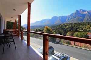 a balcony of a house with a view of the mountains at ZEFIR APARTMENTS in Buşteni