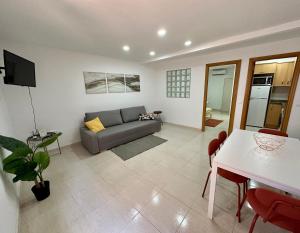 a living room with a couch and a table at Little Horse apartments 3 in Tarragona
