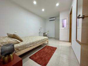 a bedroom with a bed and a red rug at Little Horse apartments 3 in Tarragona
