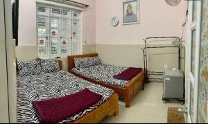 Giường trong phòng chung tại Homestay VT