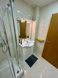 a bathroom with a sink and a shower at Little Horse apartments 3 in Tarragona