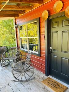 a front porch of a house with a door at Acorn Hideaways Canton Gold Panner Bunkhouse King Bed in Canton