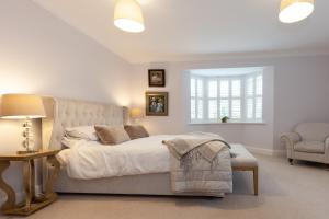 a bedroom with a bed and a chair and a window at The Woodstock Hideaway - Breathtaking 4BDR House in Woodstock