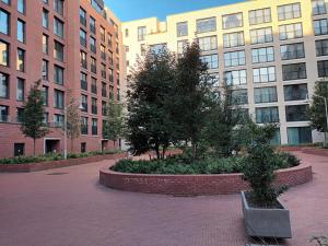 a courtyard with trees in front of tall buildings at Gallery Home in Brussels