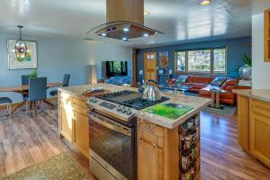 a kitchen with a stove and a living room at Peaceful Sedona Home - Walk to Amitabha Stupa! in Sedona