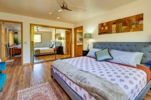 a bedroom with a bed and a living room at Peaceful Sedona Home - Walk to Amitabha Stupa! in Sedona
